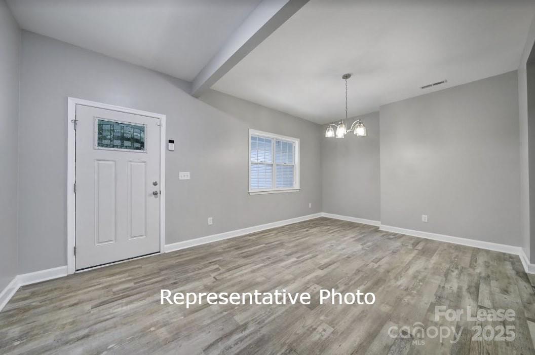 595 Foxwood Drive Southeast Concord, NC 28025 - Photo 3 of 8 a view of an empty room with window and wooden floor