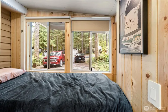 a bed sitting in a bedroom next to a window
