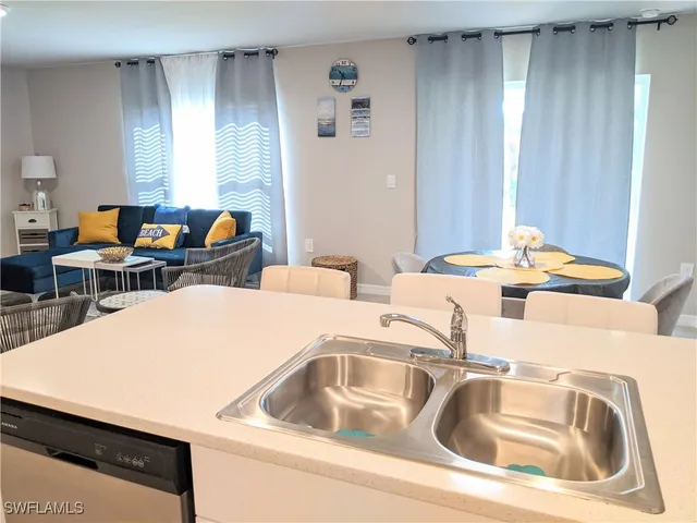 a living room with two couches and dinning table