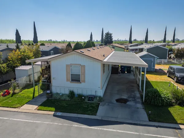 a aerial view of a house with a yard and potted plants