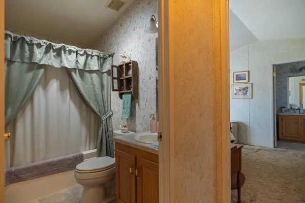 a bathroom with a toilet and a shower