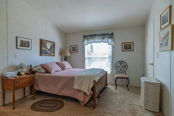 a bedroom with a bed and a chair