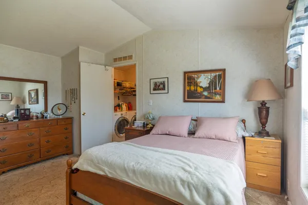 a bedroom with a bed and a dresser in it