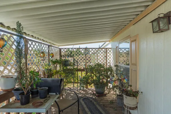 a balcony with chairs and table