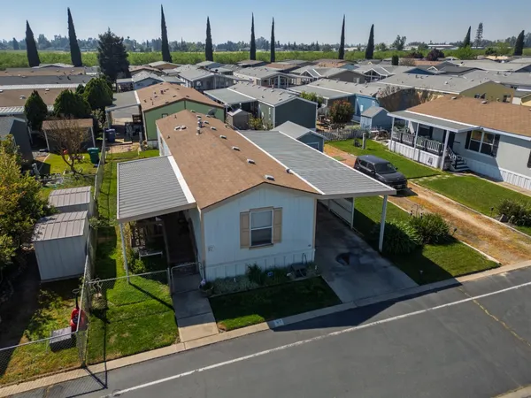 an aerial view of residential houses with yard