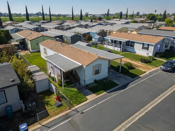 an aerial view of residential houses with yard