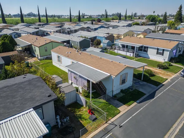 an aerial view of a house with a garden and lake view