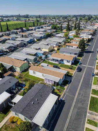 an aerial view of residential houses with outdoor space