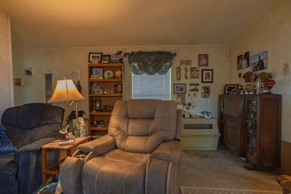 a living room with furniture a ceiling fan and a window