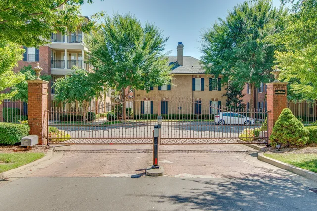 a front view of a residential apartment building with a yard