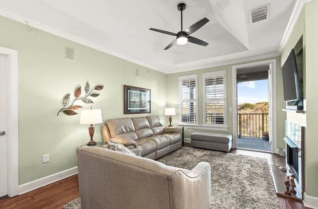 a living room with furniture a flat screen tv and a fireplace