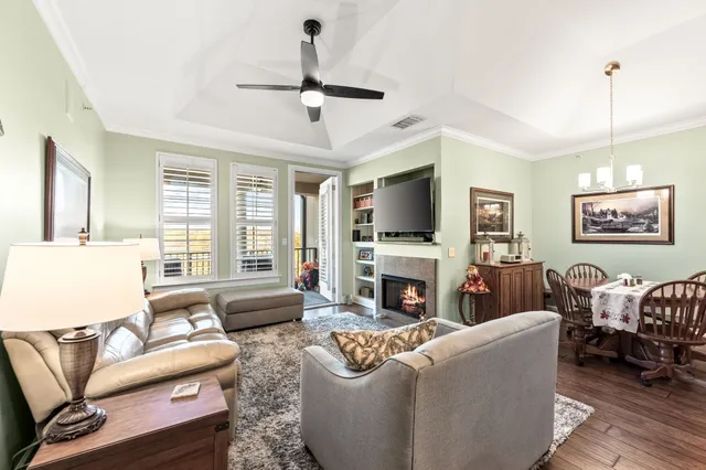 a living room with furniture a fireplace and a flat screen tv