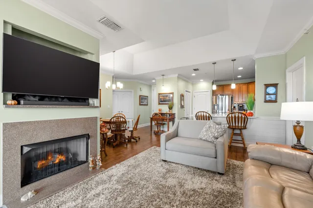 a view of a dining room with furniture a kitchen and chandelier