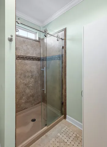 a bathroom with a granite countertop double vanity and a mirror