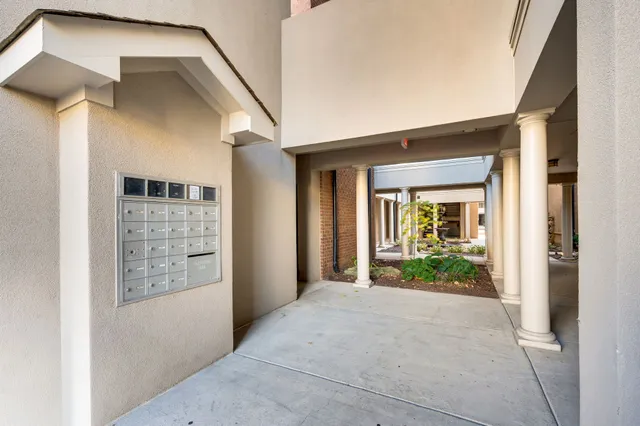 a living room with furniture and floor to ceiling windows