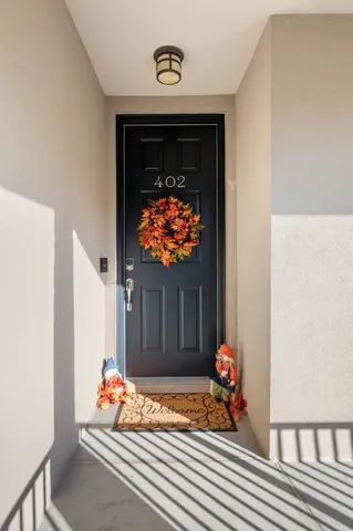 a view of a room with wooden floor and a ceiling fan