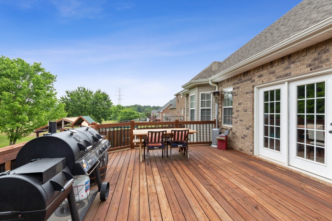 52 Abbey Road Lebanon, TN 37090 - Photo 35 of 40 a view of a roof deck with table and chairs couches with wooden floor and fence