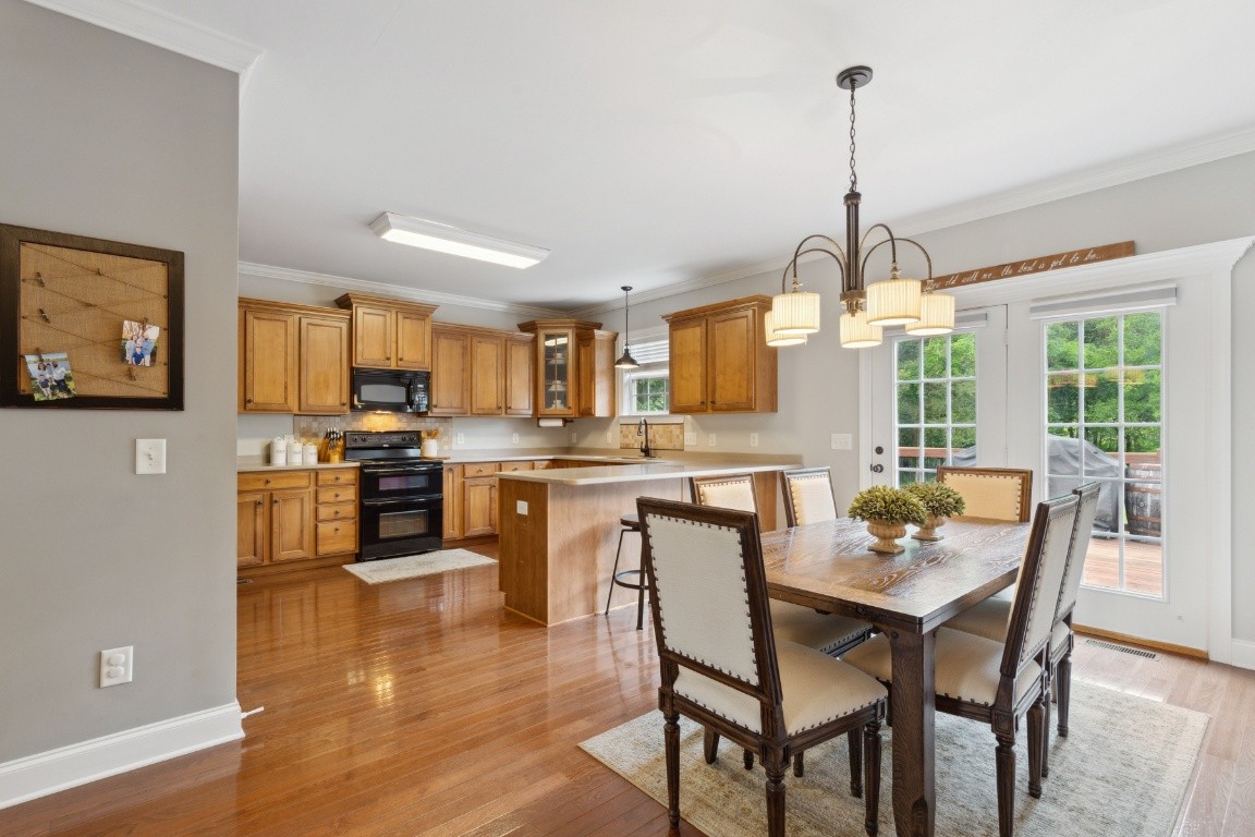 52 Abbey Road Lebanon, TN 37090 - Photo 10 of 40 a view of a dining room and livingroom with furniture wooden floor a chandelier