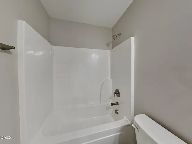a bathroom with a bathtub and a toilet