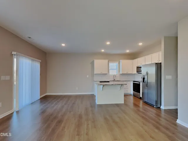 a kitchen with stainless steel appliances a refrigerator and a stove top oven