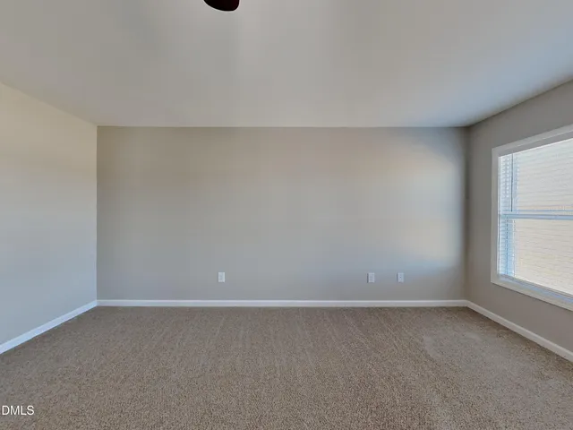 a view of an empty room and a window