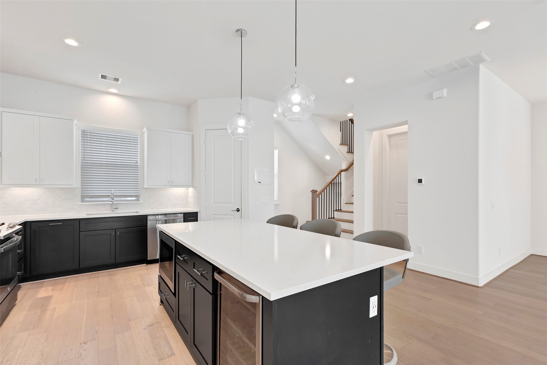 1740 Ojeman Point Lane Houston, TX 77055 - Photo 12 of 20 a large kitchen with kitchen island a sink a stove a center island a stove and a window