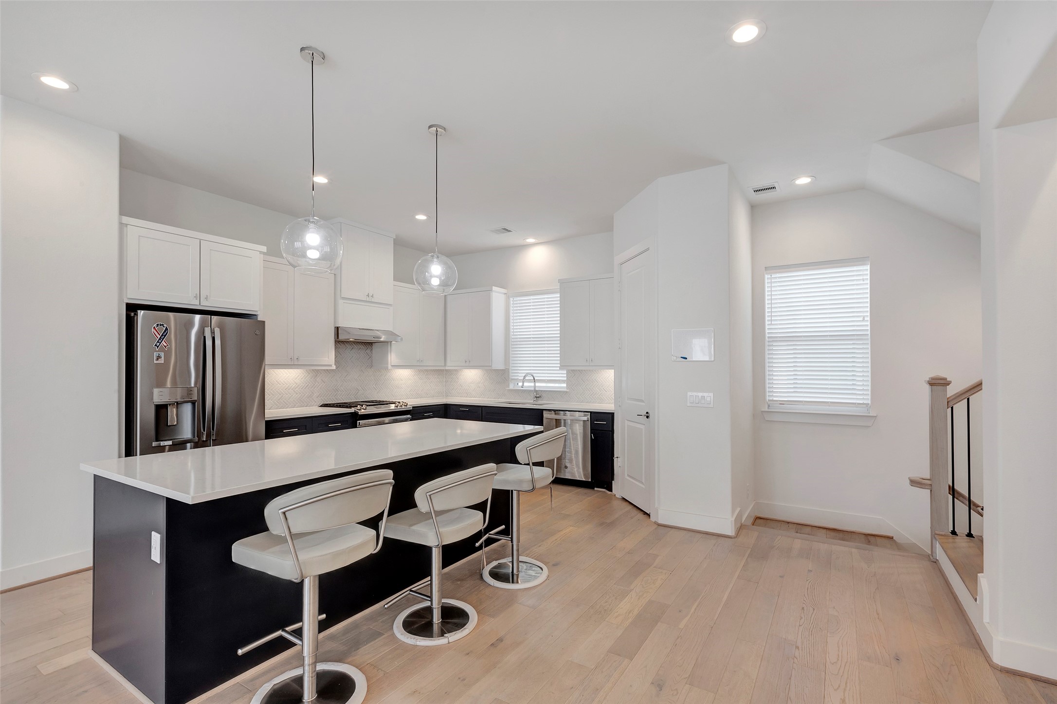 1740 Ojeman Point Lane Houston, TX 77055 - Photo 14 of 20 a large kitchen with a table chairs stainless steel appliances and cabinets