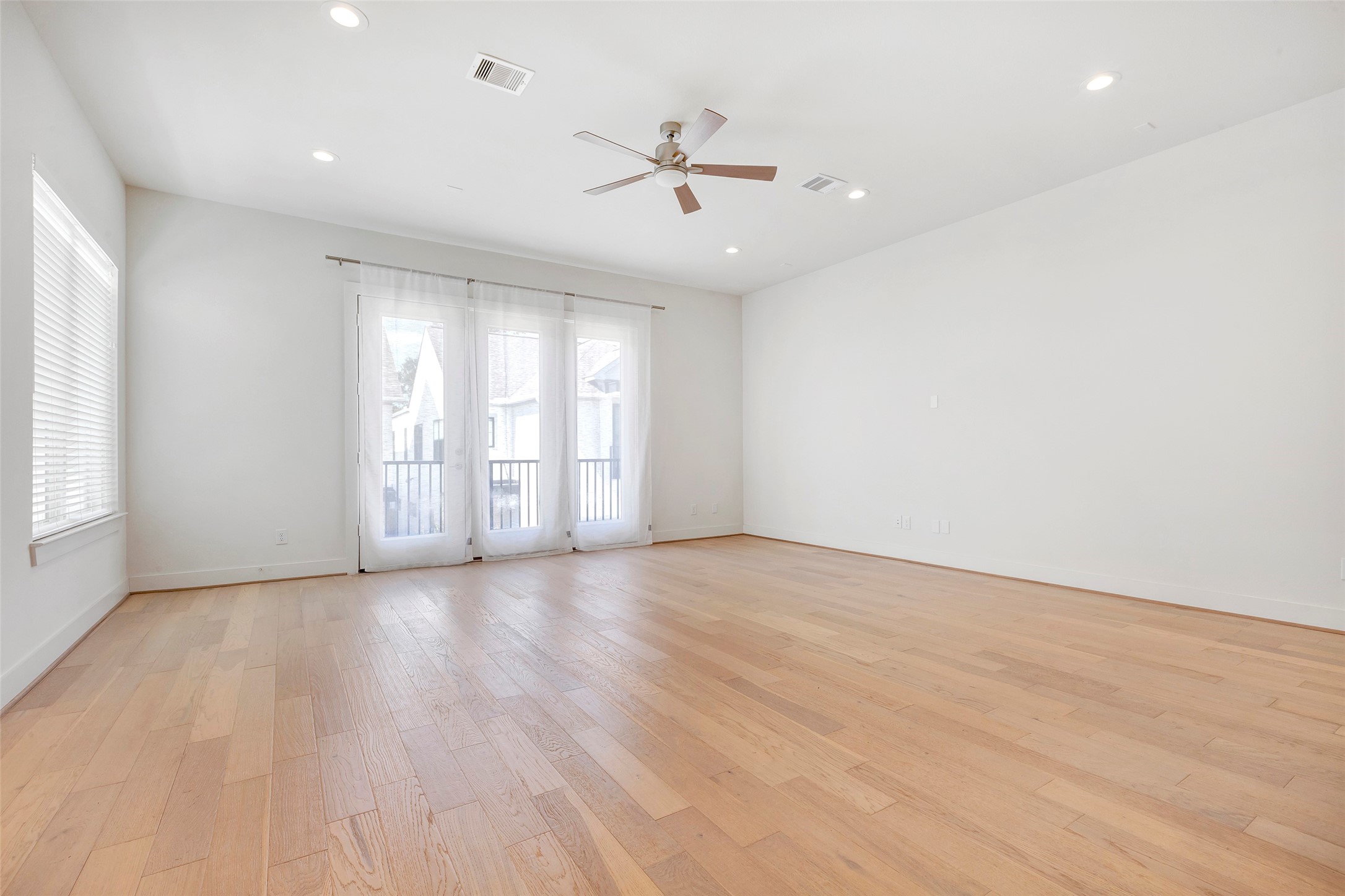 1740 Ojeman Point Lane Houston, TX 77055 - Photo 7 of 20 an empty room with wooden floor fan and windows