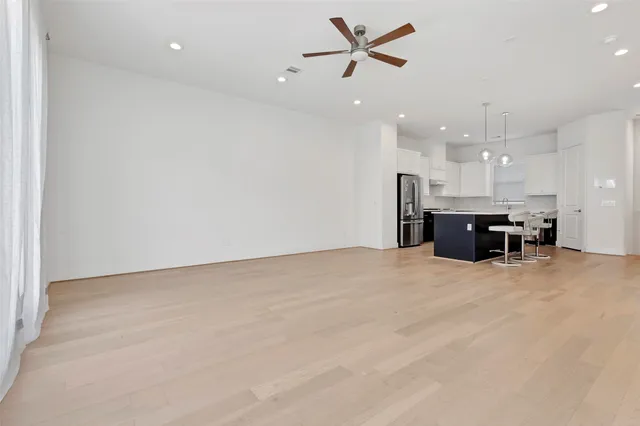 a kitchen with cabinets and chairs