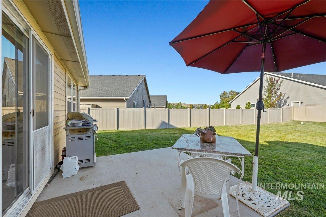 3174 North Greengate Way Star, ID 83669 - Photo 17 of 35 Fenced backyard with a patio area, area for grilling, and outdoor dining area