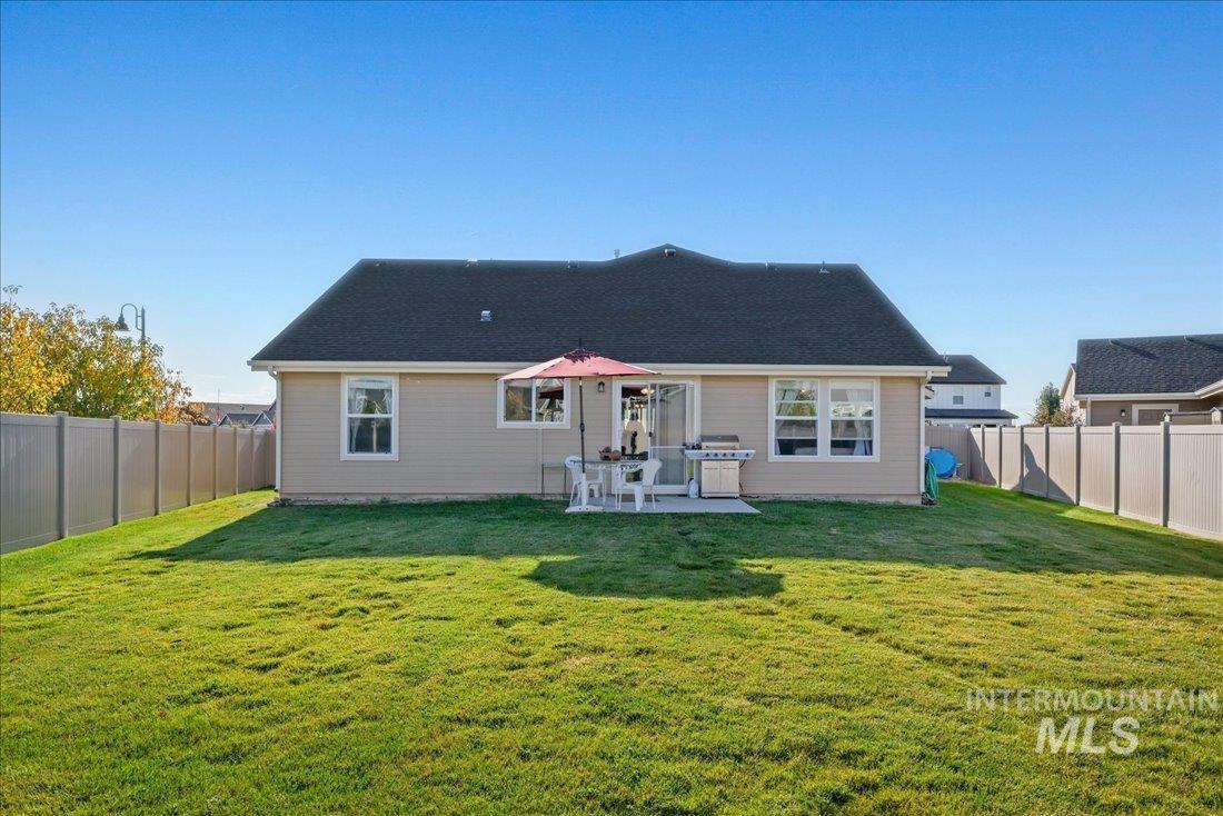 3174 North Greengate Way Star, ID 83669 - Photo 18 of 35 Back of property featuring a fenced backyard and a patio area