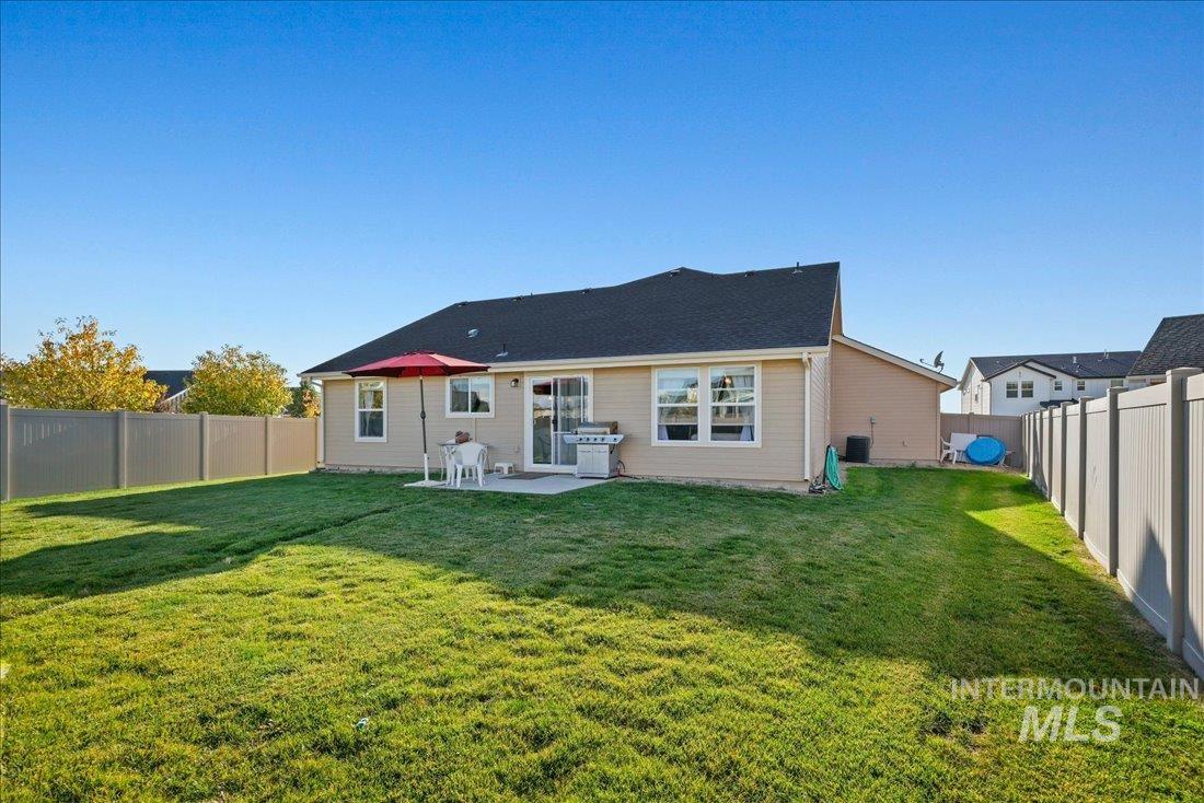 3174 North Greengate Way Star, ID 83669 - Photo 21 of 35 Rear view of property featuring a fenced backyard and a patio