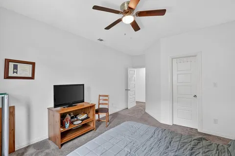 a bedroom with furniture and a flat screen tv