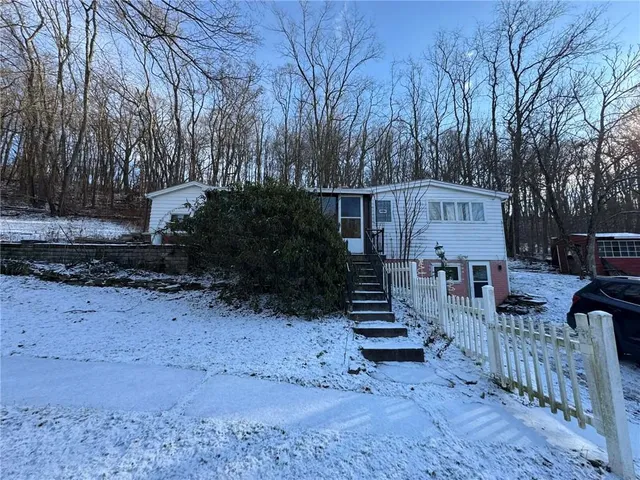 a view of a house with wooden fence