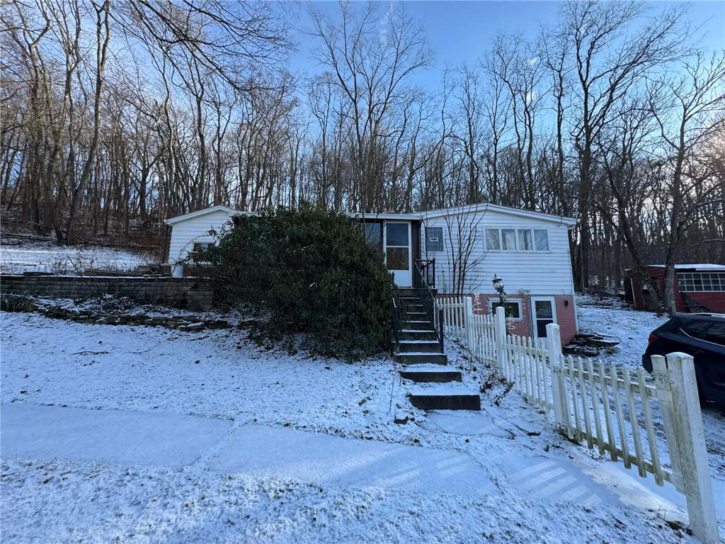 a view of a house with wooden fence