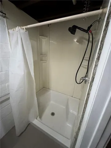 a bathroom with a shower and a bath tub