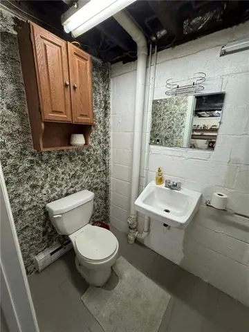 a bathroom with a toilet a sink and a mirror