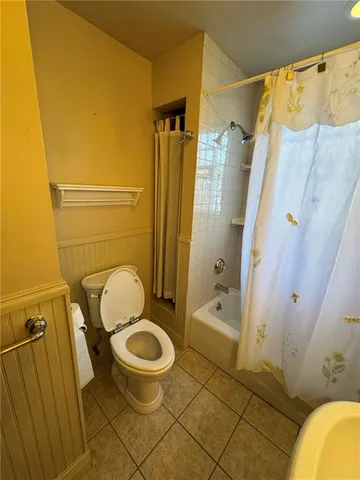 a bathroom with a granite countertop toilet sink and shower