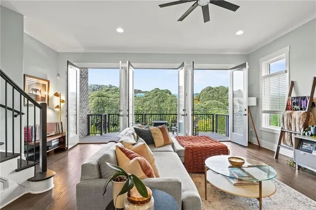 a living room with furniture and a floor to ceiling window