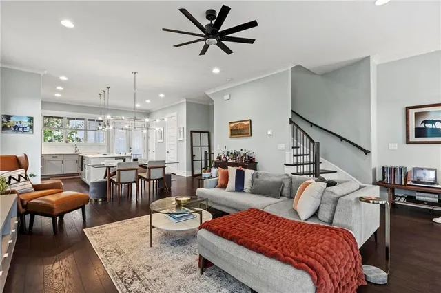 a living room with furniture and wooden floor