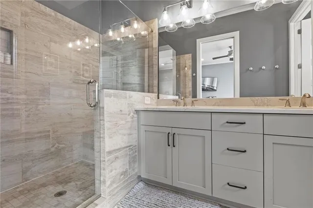 a bathroom with a sink shower and a mirror