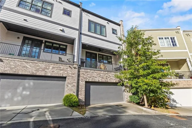 a front view of a house with plants