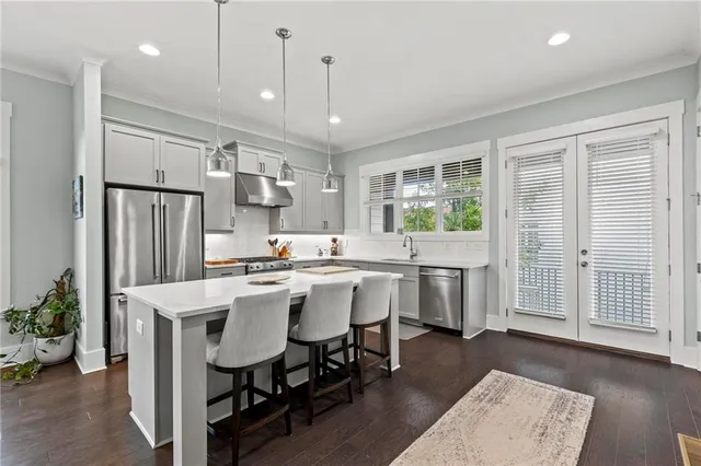 a kitchen with a table chairs refrigerator and microwave