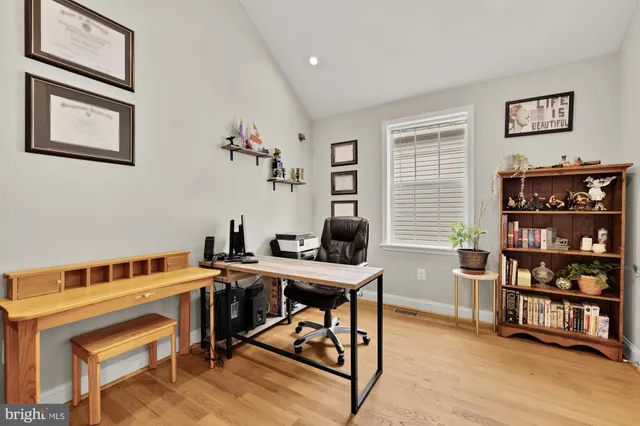 a view of a workspace with furniture and wooden floor