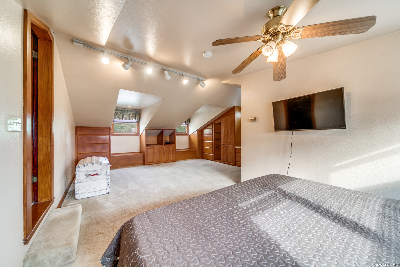1201 Sisterdale Road Boerne, TX 78006 - Photo 10 of 17 a bedroom with a bed and a flat screen tv
