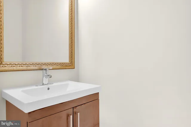 a view of kitchen with granite countertop cabinets stainless steel appliances and a fireplace
