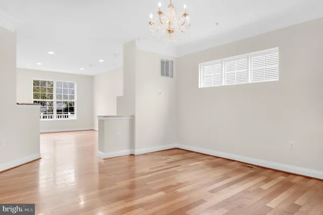 a living room with fireplace furniture and a view of kitchen