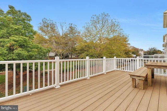 a kitchen with stainless steel appliances granite countertop a refrigerator a stove and a sink with wooden cabinets