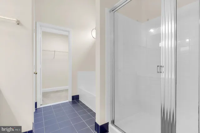 a front view of a house with a garden and trees