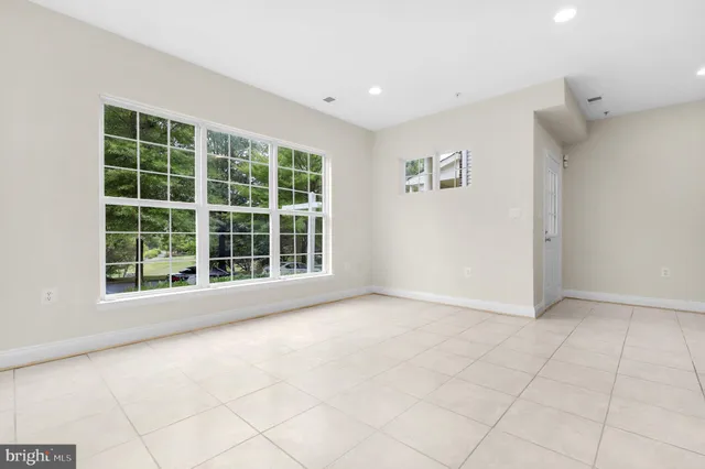 a view of empty room with wooden floor and cabinet